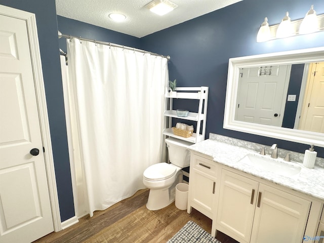 2072 Madison Villas Way Unit 2072, Madison, AL 35758 - bathroom featuring wood finished floors, vanity, toilet, a textured ceiling, and a shower with curtain
