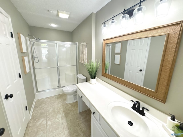 2072 Madison Villas Way Unit 2072, Madison, AL 35758 - bathroom featuring vanity, a stall shower, toilet, tile patterned floors, and a textured ceiling