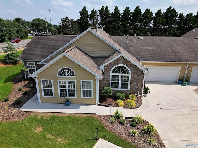 2072 Madison Villas Way Unit 2072, Madison, AL 35758 - view of front of property with concrete driveway, stone siding, a front yard, and a shingled roof
