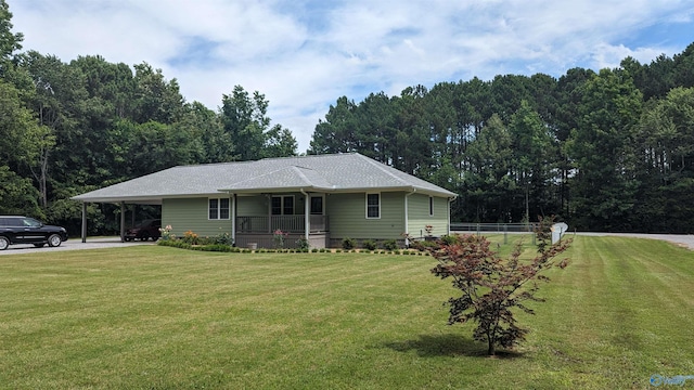 view of front facade with a carport, a porch, and a front yard