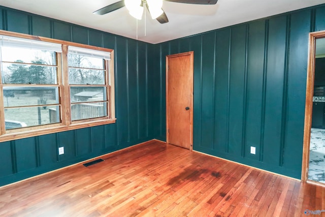 6670 Moores Mill Rd, Huntsville, AL 35811 - spare room with ceiling fan, a decorative wall, hardwood / wood-style flooring, and visible vents
