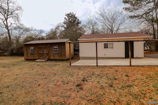6670 Moores Mill Rd, Huntsville, AL 35811 - back of house featuring a storage shed, a lawn, an outdoor structure, and a patio area