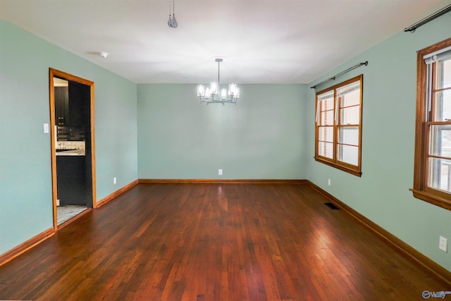 6670 Moores Mill Rd, Huntsville, AL 35811 - empty room with baseboards, a chandelier, plenty of natural light, and hardwood / wood-style flooring