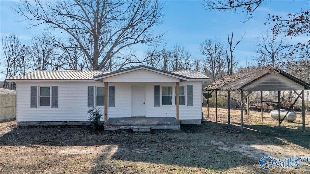 view of front of property with covered porch and a carport