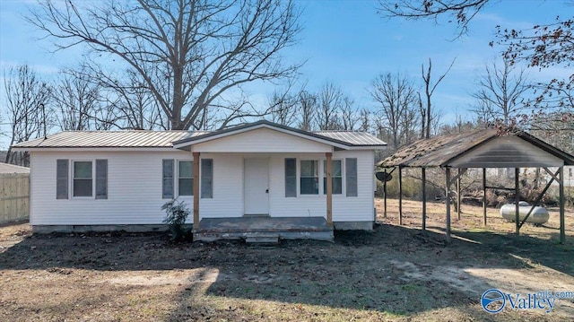 view of front of property with covered porch and a carport