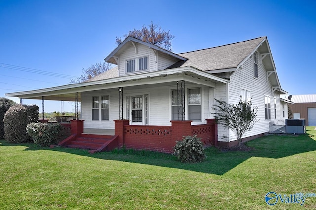 view of front of home featuring central AC unit, a porch, and a front lawn