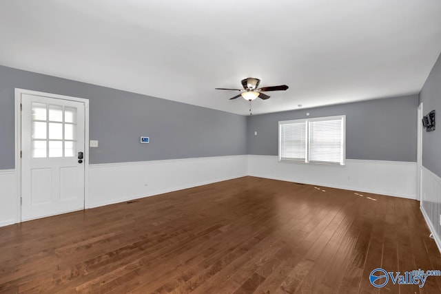 empty room featuring dark hardwood / wood-style flooring and ceiling fan