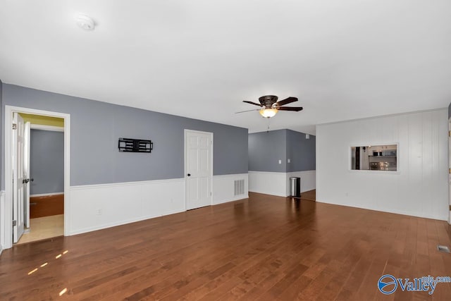 unfurnished living room with ceiling fan and hardwood / wood-style floors