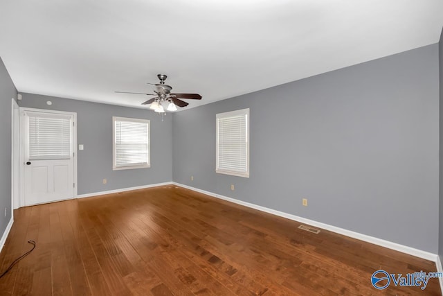 spare room featuring hardwood / wood-style floors and ceiling fan