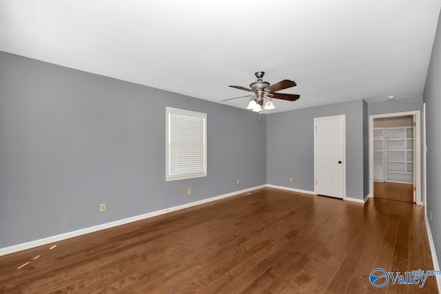 unfurnished room with ceiling fan and dark hardwood / wood-style flooring