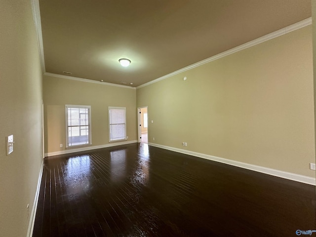 spare room featuring dark hardwood / wood-style floors and ornamental molding