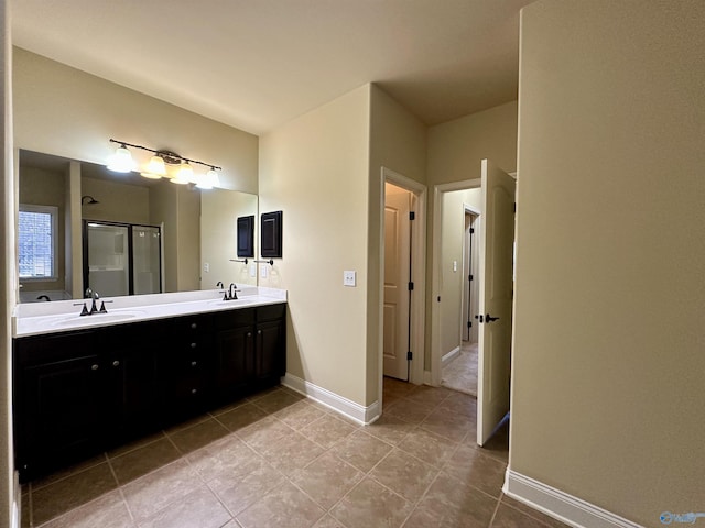 bathroom with tile patterned flooring, vanity, and a shower with shower door