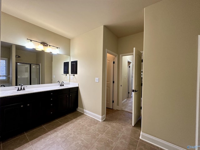 bathroom featuring tile patterned flooring, vanity, and a shower with door