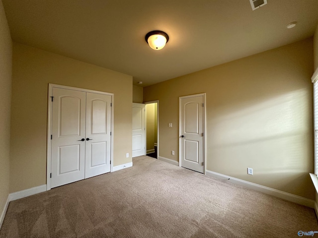 unfurnished bedroom with a closet and carpet