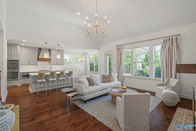 51 Summerlyn Way SE, Gurley, AL 35748 - living area featuring a chandelier, dark wood-type flooring, recessed lighting, baseboards, and a high ceiling