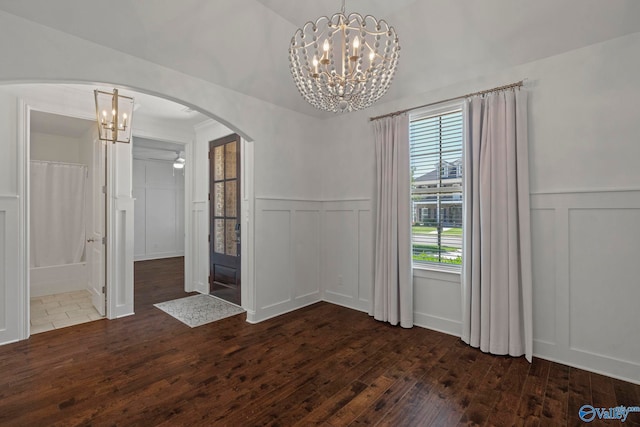 51 Summerlyn Way SE, Gurley, AL 35748 - unfurnished dining area featuring a decorative wall, a chandelier, dark wood-style floors, arched walkways, and a wainscoted wall