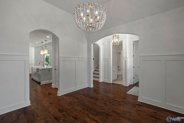 51 Summerlyn Way SE, Gurley, AL 35748 - unfurnished dining area featuring a decorative wall, dark wood finished floors, a chandelier, stairway, and arched walkways