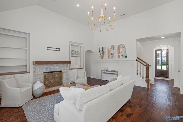 51 Summerlyn Way SE, Gurley, AL 35748 - living room with arched walkways, a chandelier, built in shelves, stairway, and high vaulted ceiling