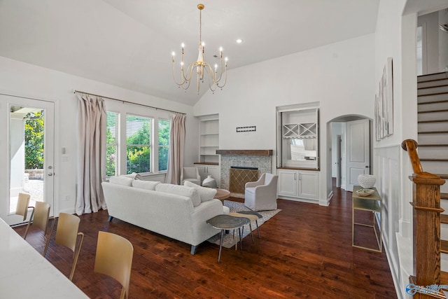 51 Summerlyn Way SE, Gurley, AL 35748 - living room featuring stairway, high vaulted ceiling, built in features, arched walkways, and dark wood-type flooring