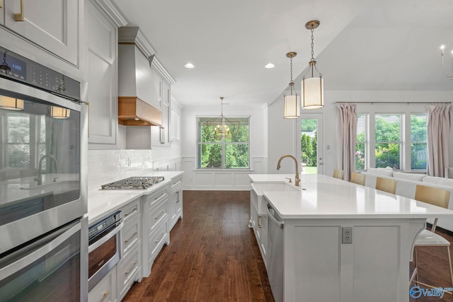 51 Summerlyn Way SE, Gurley, AL 35748 - kitchen with stainless steel appliances, dark wood-style flooring, light countertops, a sink, and wainscoting