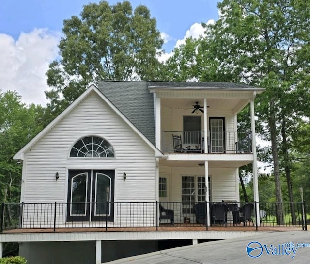 rear view of house with a balcony and ceiling fan