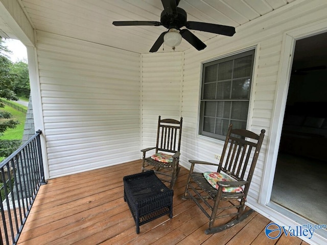 wooden deck featuring ceiling fan