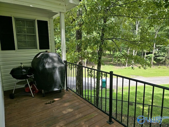 deck featuring grilling area and a yard