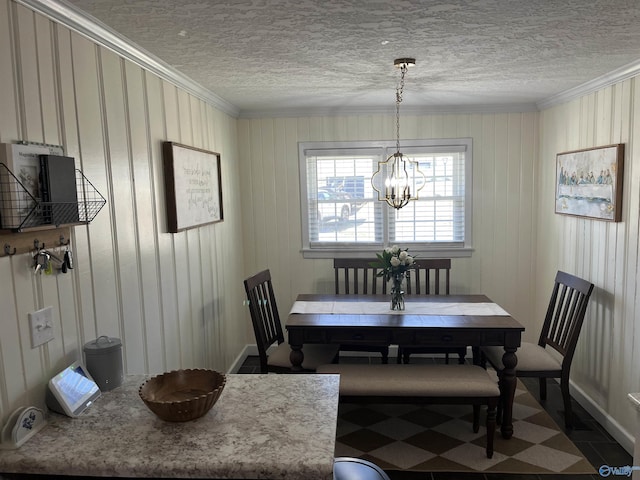 dining area featuring a notable chandelier, crown molding, and a textured ceiling