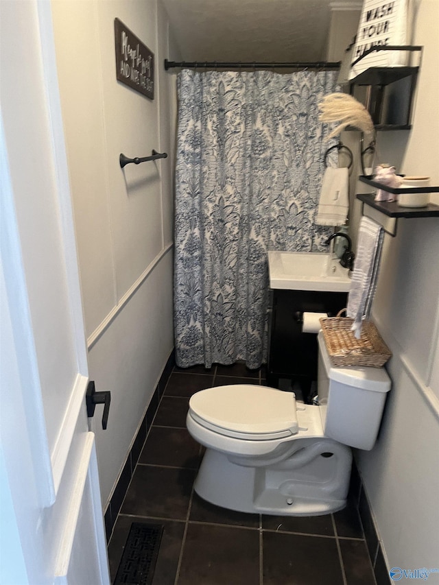 bathroom with vanity, tile patterned flooring, and toilet