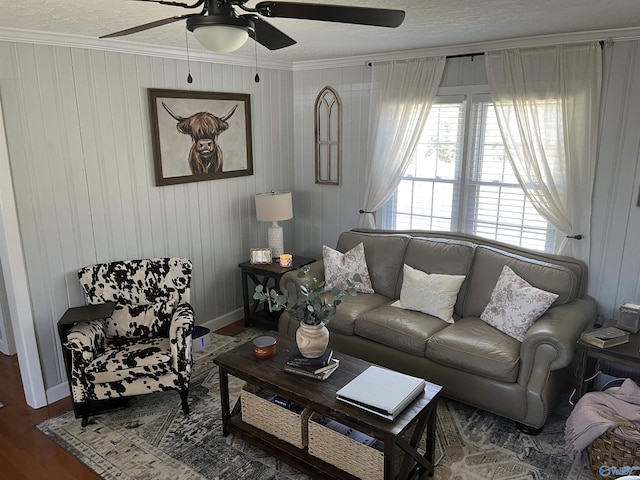 living room featuring ceiling fan, crown molding, and dark wood-type flooring