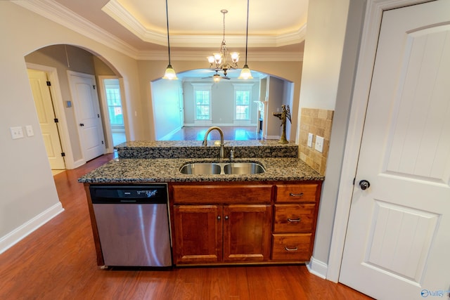 kitchen with sink, hanging light fixtures, dishwasher, and a raised ceiling