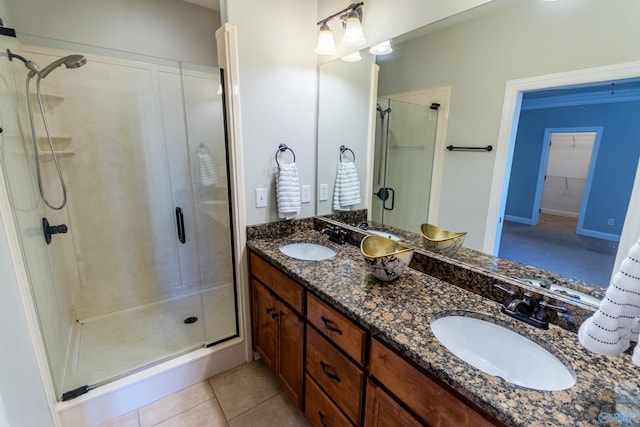 bathroom with an enclosed shower, vanity, and tile patterned flooring