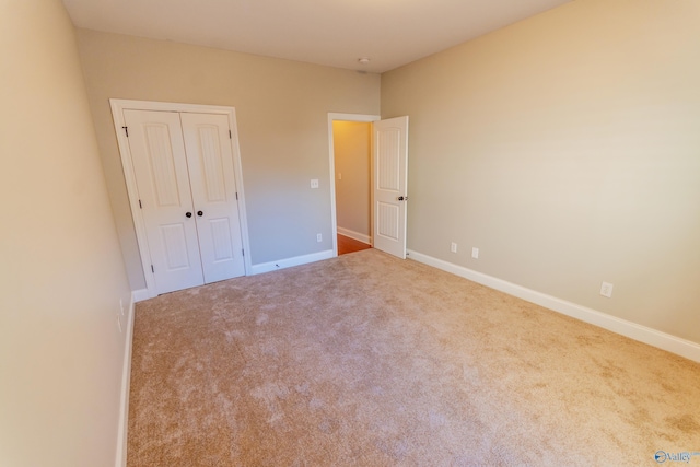 unfurnished bedroom with carpet and a closet