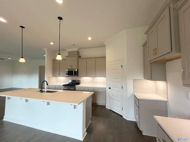 kitchen featuring stainless steel appliances, pendant lighting, sink, and gray cabinetry