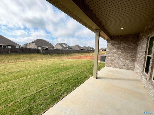 view of yard with central AC and a patio area