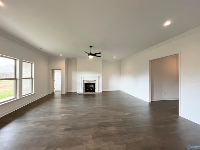 unfurnished living room with dark hardwood / wood-style flooring, crown molding, and ceiling fan