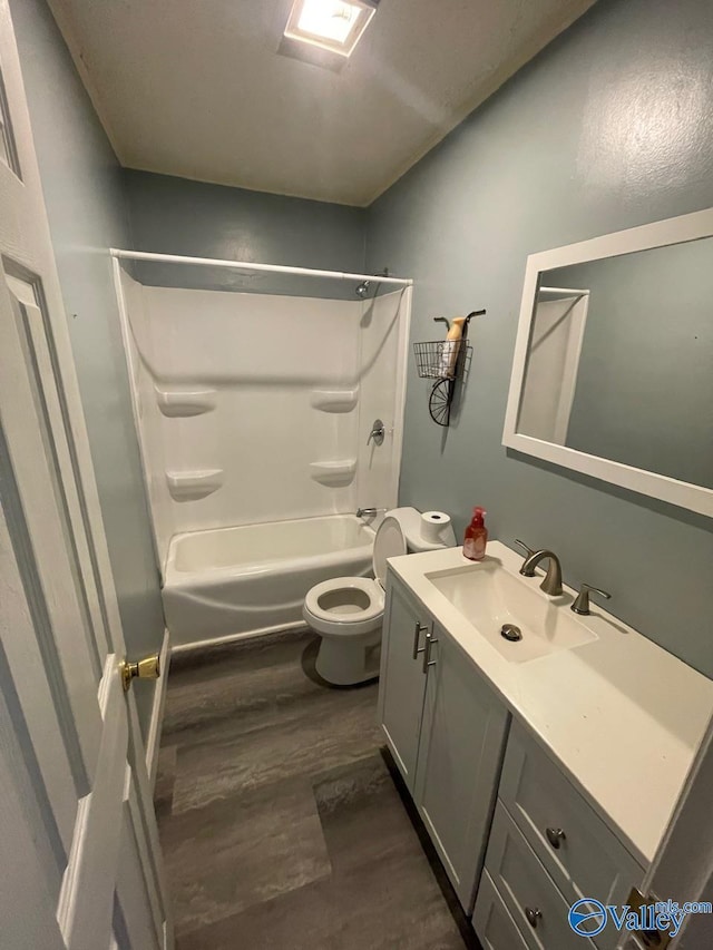 full bathroom with shower / tub combination, hardwood / wood-style floors, vanity, and toilet