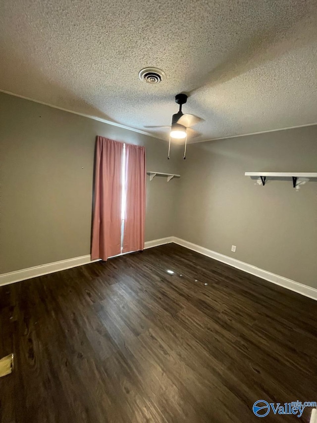 unfurnished room with dark hardwood / wood-style flooring, a textured ceiling, and ceiling fan