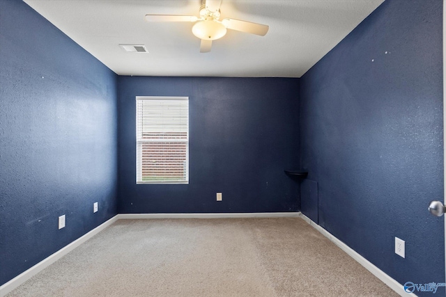 carpeted empty room featuring ceiling fan