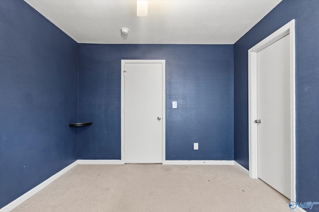 unfurnished bedroom featuring light carpet and ceiling fan