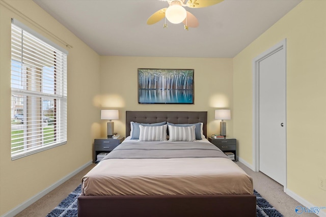 bedroom featuring light colored carpet and ceiling fan