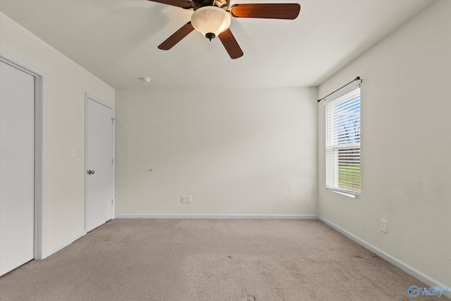 spare room featuring ceiling fan and light colored carpet