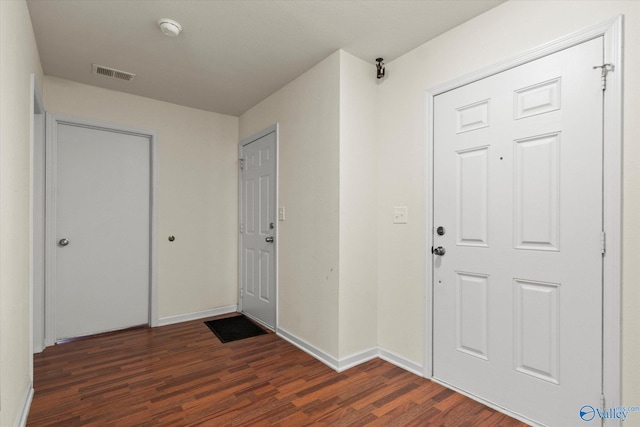 entryway with dark wood-type flooring