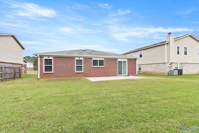 back of house with a yard, a patio area, and central air condition unit