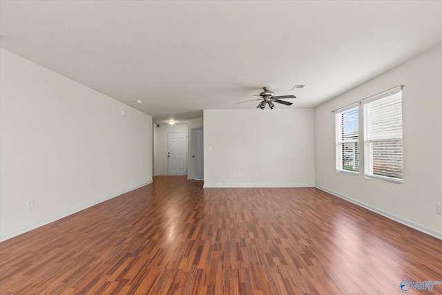 spare room featuring ceiling fan and dark hardwood / wood-style flooring