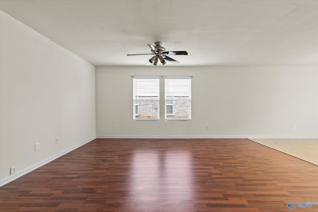 spare room with ceiling fan and dark hardwood / wood-style flooring