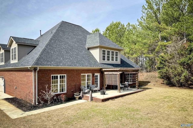 rear view of property with a lawn and a patio