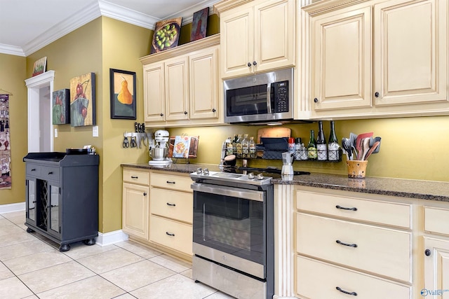 kitchen featuring appliances with stainless steel finishes, light tile patterned flooring, cream cabinetry, and crown molding