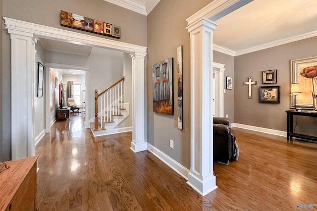 entrance foyer with ornate columns, crown molding, and wood-type flooring