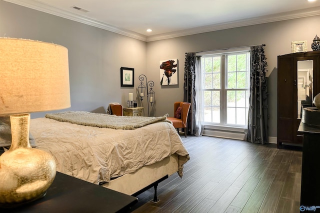 bedroom featuring crown molding and dark wood-type flooring